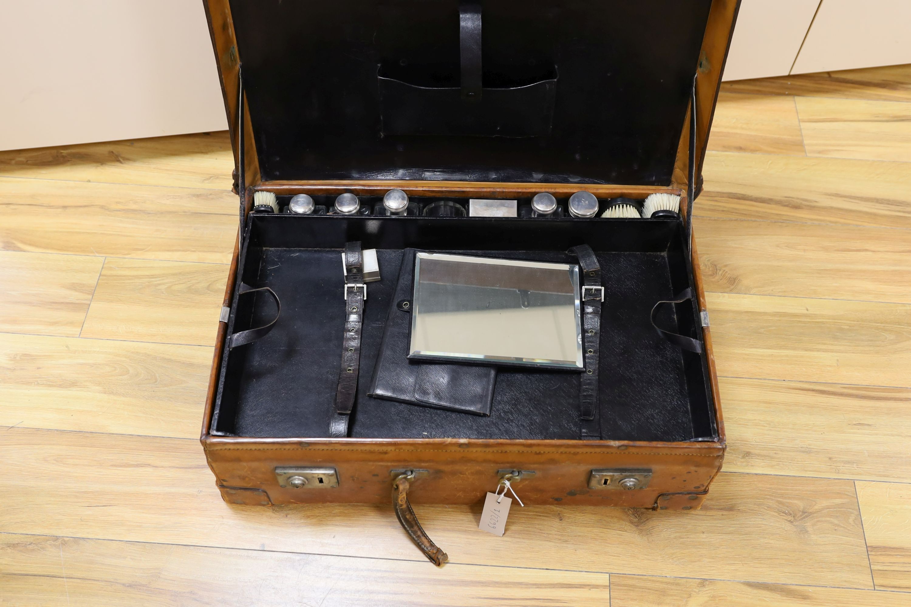 A Dupont travel suitcase, initialled ‘L.C.’ with French white metal mounted bottles